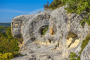 Ancient stone caves in a town-fortess Eski-Kermen high in a rocky mountains, Crimea