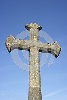 Ancient stone cross against blue sky