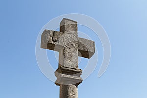 Ancient Stone Cross with Solar Marking and Blue Sky