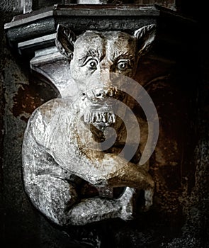 Ancient stone demon sculpture. Gothic church decoration