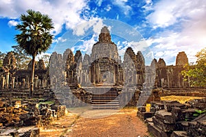 Ancient stone faces at sunset of Bayon temple, Angkor Wat.