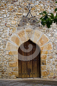 Ancient stone flaming arch door and two steel grills.
