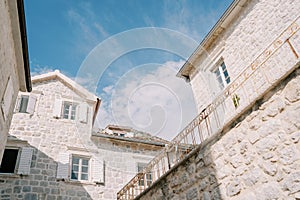 Ancient stone houses with attics against a blue sky photo
