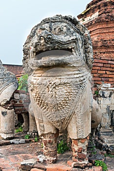 Ancient, stone lion sculpture at ancient ruines buddhist temple