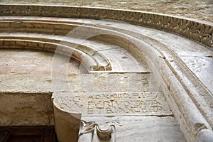 Ancient stone portal with sculptures, madonna delle grotte church, italy