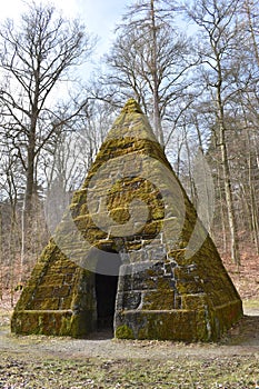 Ancient stone pyramid with moss in the forest on the way to the World Cultural Heritage Herkules in Kassel, WilhelmshÃ¶he, Germany