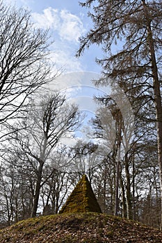 Ancient stone pyramid with moss in the forest on the way to the World Cultural Heritage Herkules in Kassel, WilhelmshÃ¶he, Germany