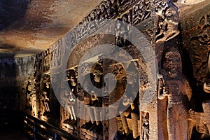 Ancient stone relief in Ajanta caves, India. The Ajanta Caves in Maharashtra state are Buddhist caves