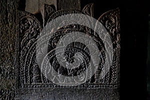 Ancient stone relief in Ajanta caves, India. The Ajanta Caves in Maharashtra state are Buddhist caves