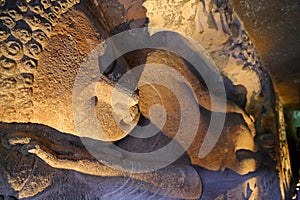 Ancient stone relief in Ajanta caves, India. The Ajanta Caves in Maharashtra state are Buddhist caves