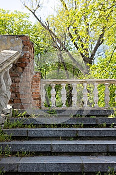 Ancient stone staircase with railings in the park.