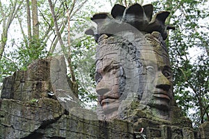 an ancient stone statue of twin faces in a temple