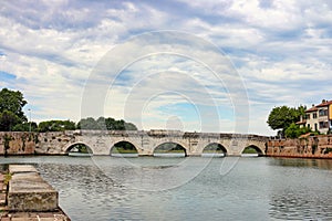 Ancient stone Tiberius bridge in Rimini photo