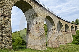 Ancient stone viaduct railway bridge in Western Ukraine in Ternopil region in the village of Plebanivka photo