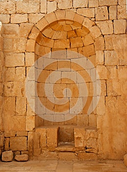 Ancient stone wall with arched niche