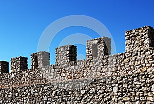 Ancient stone wall with battlements, perspective