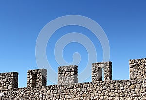 Ancient stone wall with battlements, perspective photo