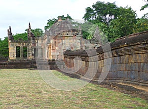 Ancient stone wall and the Gopura doorway of Prasat Hin Muang Tam Shrine Complex, Thailand