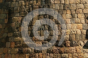 Ancient stone wall texture with sun light.