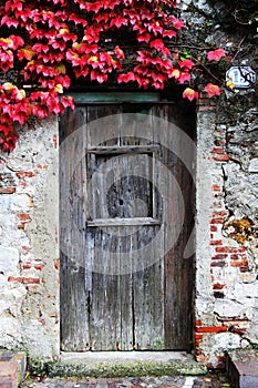 Ancient stone wall and a wooden closed door