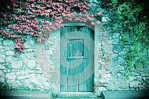 Ancient stone wall and a wooden closed door