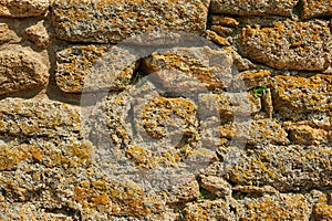 Ancient stone wall. Yellow grunge texture of brick.
