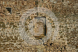 Ancient stone wall. Yellow grunge texture of brick.