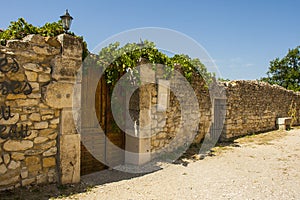 Ancient stone walls and narrow gravel streets in the historic village of Le Poet Laval in the Drome area of Provence.