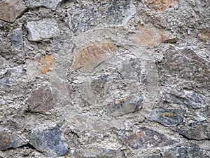 Ancient stonework. The stones are reinforced with old mortar. Uneven masonry ancient wall