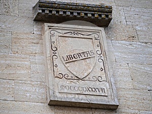 Ancient street plaque with the word Libertas, San Marino