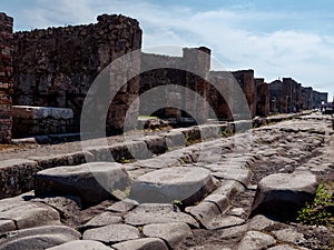 Ancient street of Pompeii Italy. Pompeii was destroyed and buried with ash and pumice after Vesuvius eruption in 79 AD.