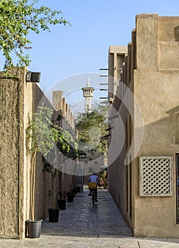 Ancient streets of Bastakiya, Dubai, with a mosque minaret at the end of the street.