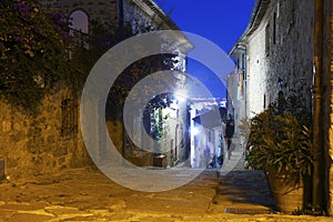 Ancient streets at night in the city `Castiglione della Pescaia`.