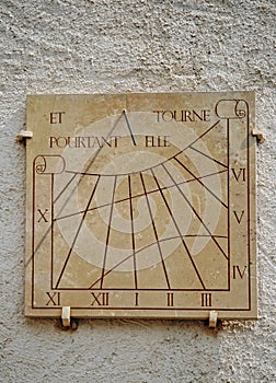 Ancient sundial or sun clock on a wall