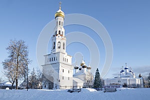 Ancient temple complex with a bell tower on a frosty January day, Zavidovo
