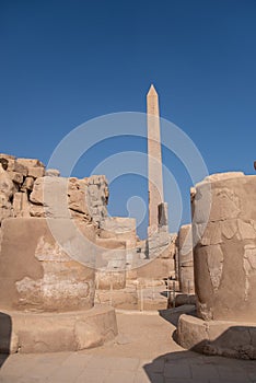 Ancient Temple of Karnak in Luxor - Ruined Thebes Egypt. Obelisk and ruined columns  at Karnak Temple. Temple of Amon-Ra