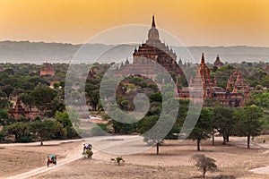 Ancient temples and carriages at sunset in Bagan, Myanmar.