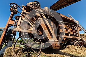 Ancient threshing machine for wheat photo