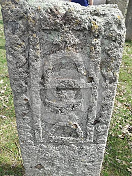 Ancient tombstone with cross in local cemetery