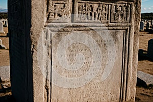 An ancient tombstone inscriptions weathered and barely legible