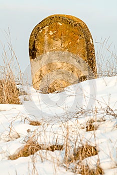 Ancient Tombstone In Winter Setting