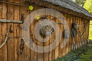 Ancient tools of labor and everyday life on the wall of a wooden barn. culture and traditions of Europe.