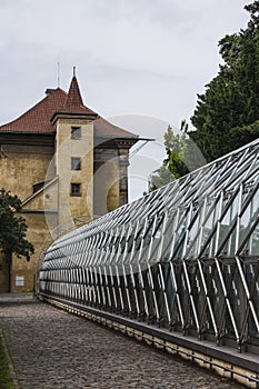 Ancient tower and modern greenhouse building in the Royal Garden near the Prague Castle. Prague. Czech Republic