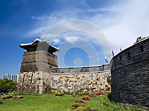 Ancient tower and ramparts walls of the UNESCO heritage site during beautiful day, Suwon, South Korea