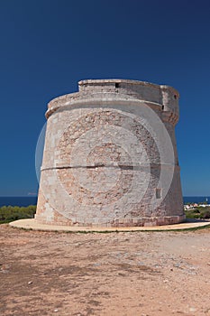 Ancient tower `Torre Son Ganxo`. Punta Prima, Minorca, Spain