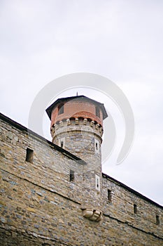 Ancient tower and wall exterior of old Kamianets-Podilskyi castle, Ukraine. Stone walls of medieval castle near canyon, historical