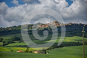 Ancient town on a hill in tuscany, villa in the foreground