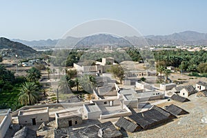 Ancient town view with houses and palm trees from top of the hill