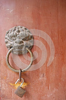 Ancient traditional red wooden door and metal lion door ring in Bingling Temple Lanzhou Gansu, China