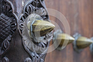 Ancient traditional wooden carved door with ornaments and bronze spike in Stone Town on island Zanzibar, Tanzania, East Africa